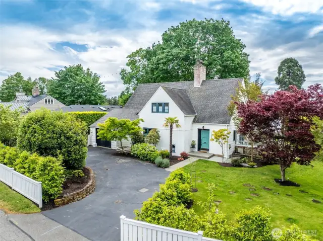 Stately manicured lot with circular driveway.