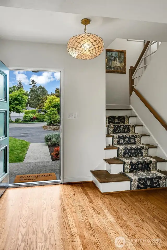 Graceful entry with beautiful hardwoods and stunning, artistic fixtures.