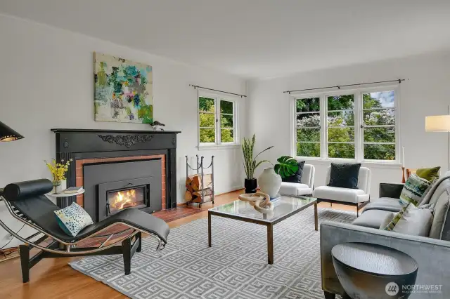 Sun-filled expansive living room with wood burning fireplace.