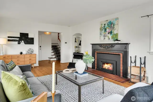 Sun-filled expansive living room with wood burning fireplace.