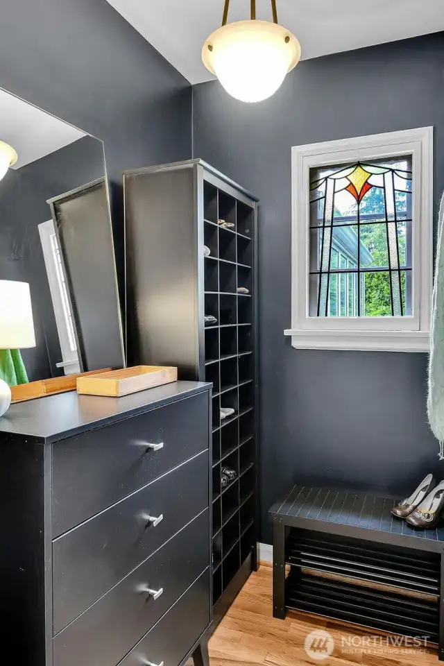 Charming mudroom off the main entrance with an abundance of storage and a half bath.