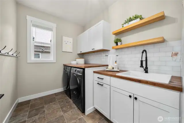 Renovated laundry room with sleek built in features