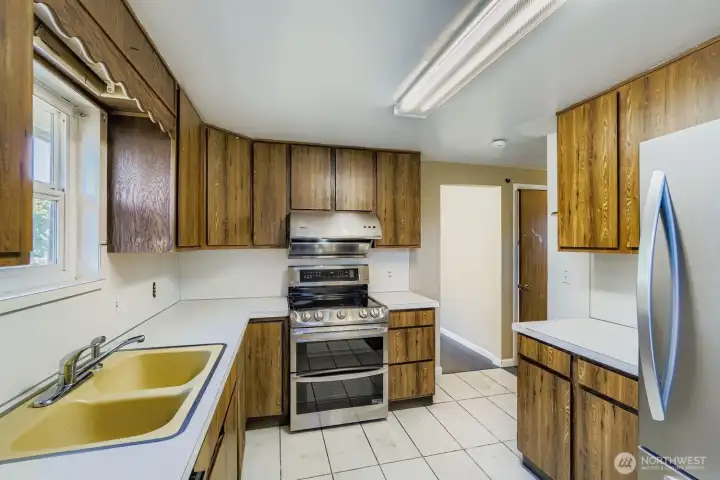 The turn-key kitchen, with new and modern appliances, is waiting for your touch to further modernize and make your own.