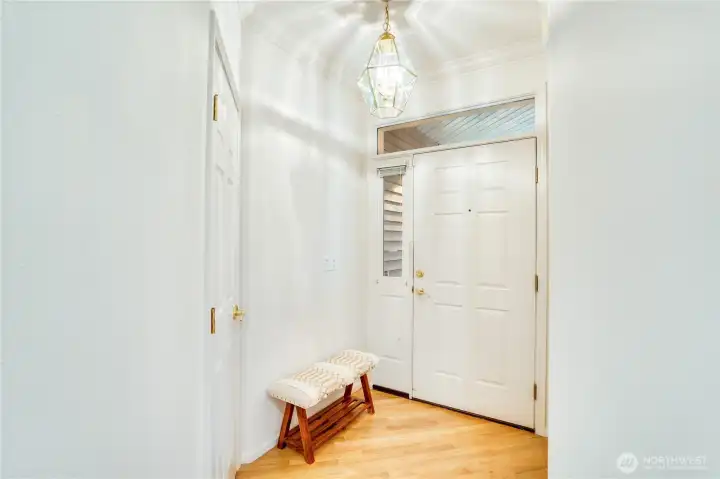 Foyer is well lit, oak floor are in wonderful condition. Traditional coat closet to your right as you enter.