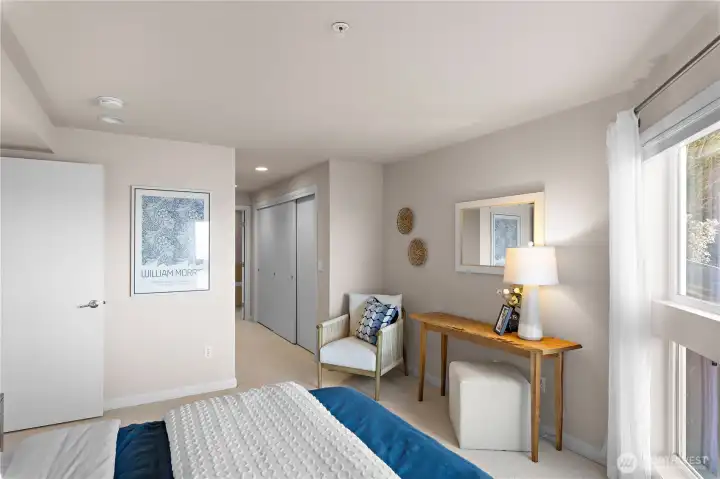 View from the primary bedroom towards the closet and ensuite bathroom.