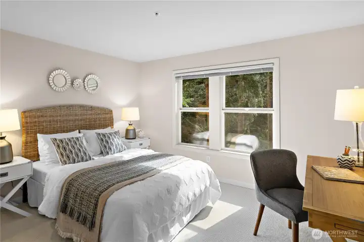 The second bedroom is tucked at the back of the condo, offering exceptional privacy with peaceful greenbelt views.