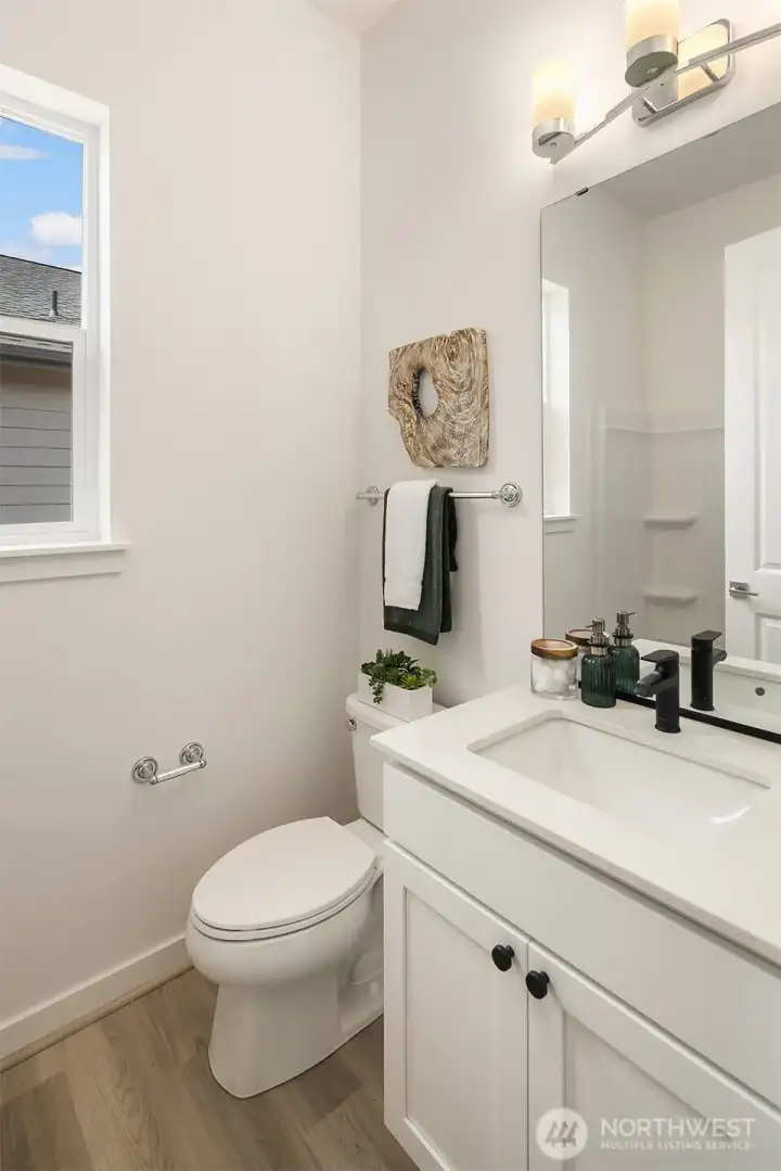 Guest bathroom with white cabinet, quartz countertop