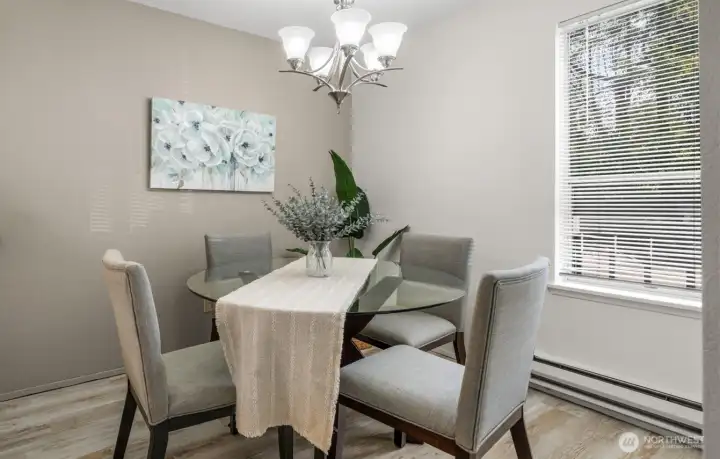 Just off the kitchen, the dining area gets a little extra sparkle from a beautiful new light fixture.