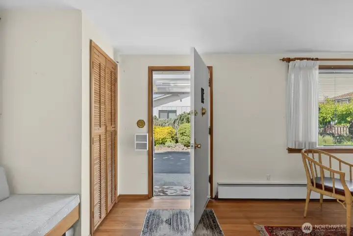 Entry way into the living room. Built in day bed with sconce lighting to left of the picture.