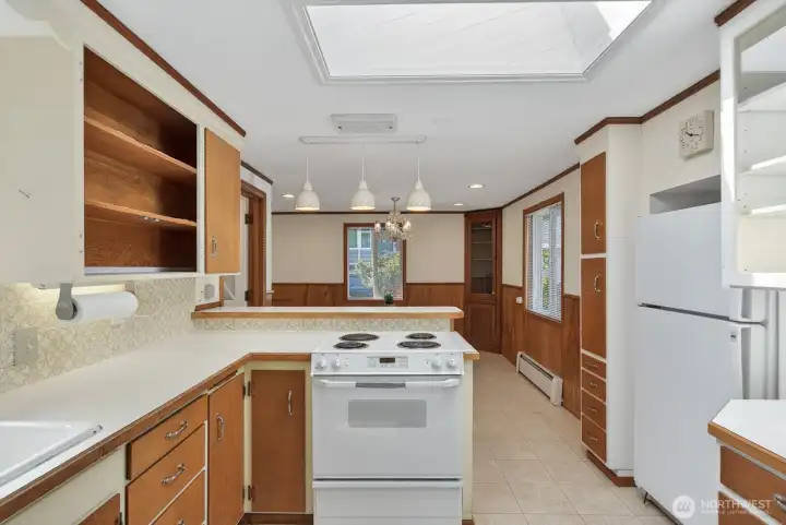 Shows kitchen flowing into the dining room.