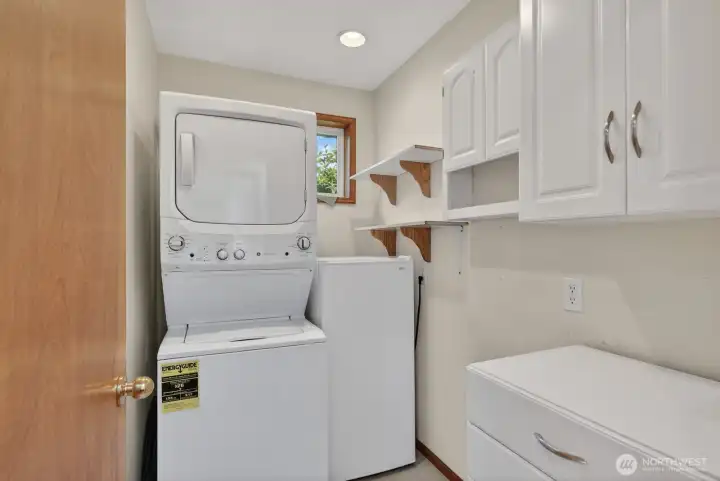 Laundry room with storage and room for small freezer.