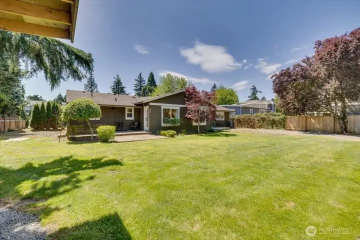 Expansive back lawn and mature landscaping