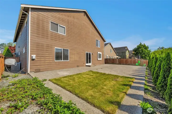 Fully fenced yard with extended patio.