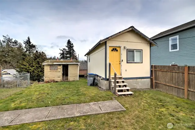 Back unit with tenant on site and single car garage below with alley access.