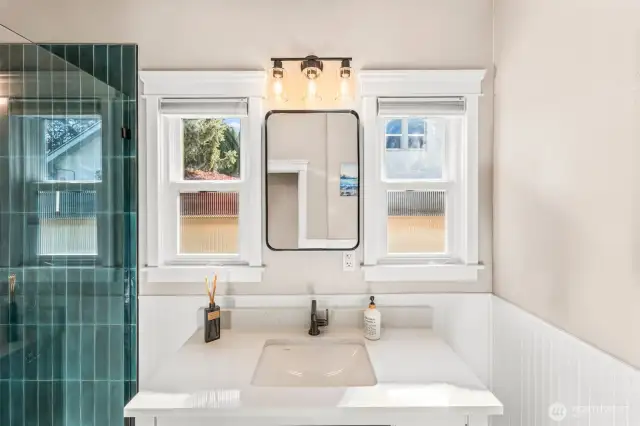 The main floor bathroom recently was updated with exquisite detail. Oversized sink in the single vanity flanked by two windows. If you looking for a bathroom with natural light and a spa like feeling here it is.