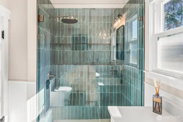 The fully tiled shower features a french drain and a full schluter shower system to make a fully waterproof showering space.