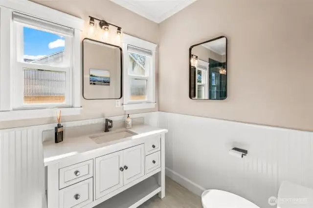 The main floor bathroom presents a spa like feeling all while paying hommage to the days of old while infusing modern finishes.