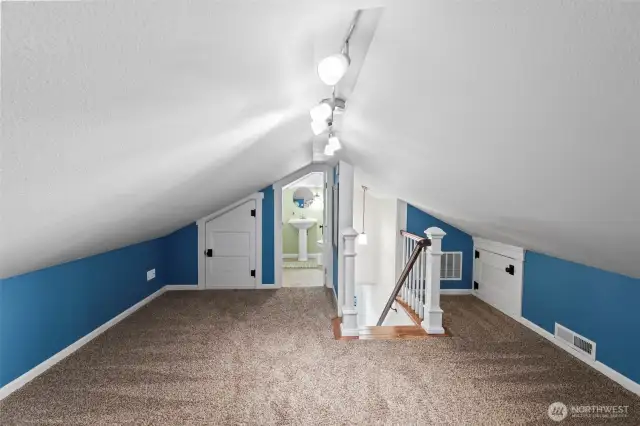 The upstairs bedroom loft features a half bath and easy attic access for a plethora of storage and the homes furnace and water heather.