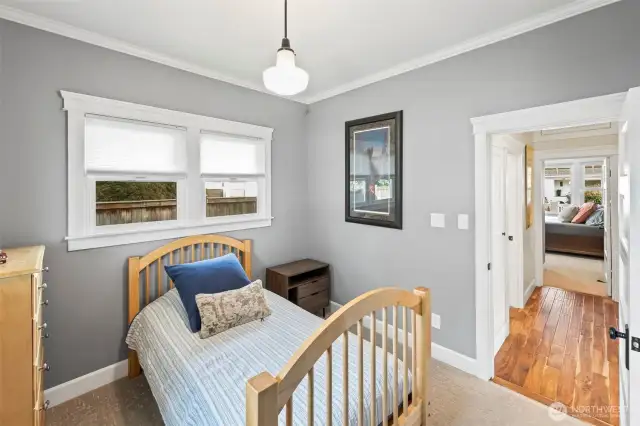 The second bedroom abuts next to the bathroom and kitchen and has for large windows to enjoy the beauty of the backyard.