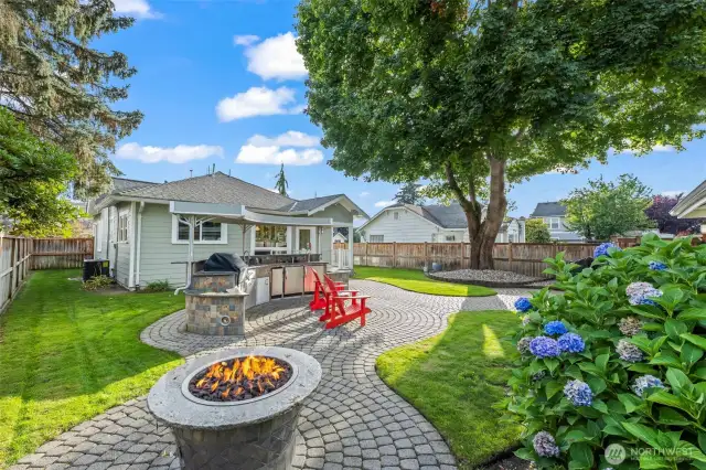 Custom designed paver patio and plumbed gas fire pit. The outdoor kitchen is prime time for the months ahead.