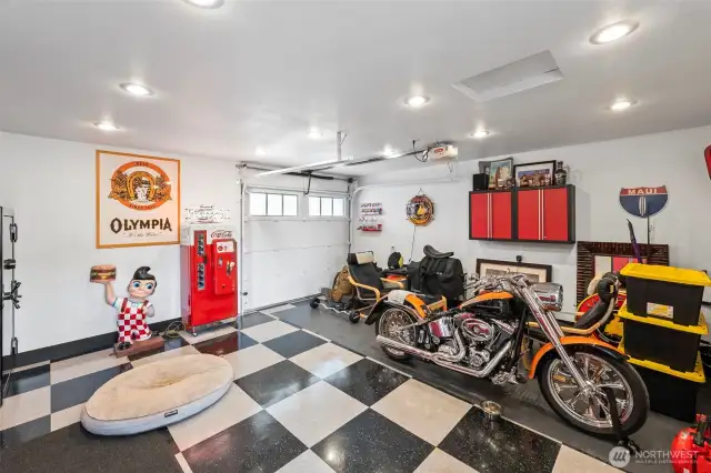 The finished garage has a checkerboard garage floor, heat and a 220 amp service.
