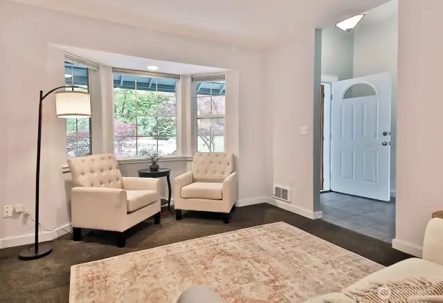 Living room or dining room, you decide. Your back is to the doorway that opens to the kitchen and you are looking back at the covered front porch and foyer. There is a coat closet in the foyer. The carpet throughout the house is in great condition and has been cleaned.