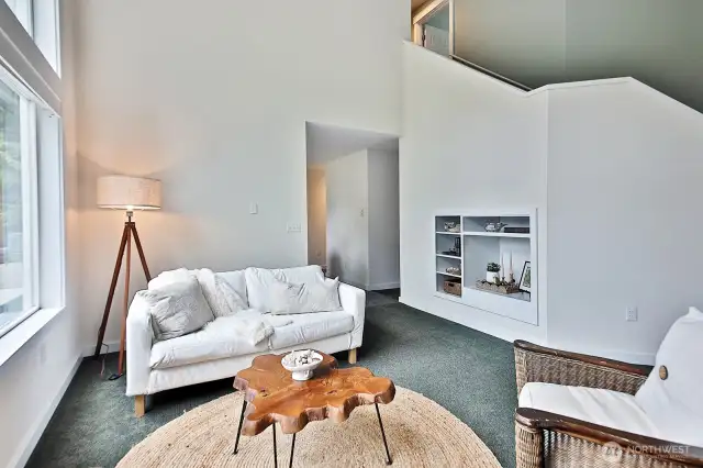 Standing at the fireplace and looking towards the kitchen.