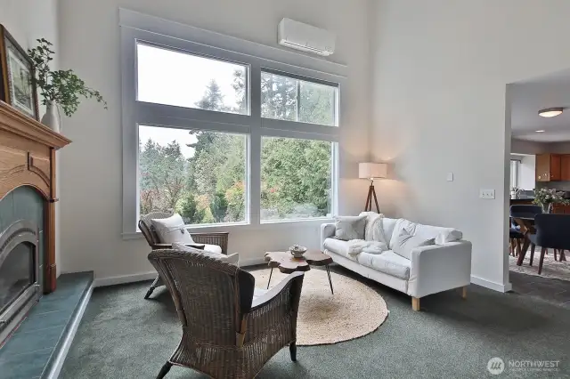 Another view of the family room (note the mini-split above the windows) and a glimpse into the kitchen and dining area. Let's check out your spacious kitchen.