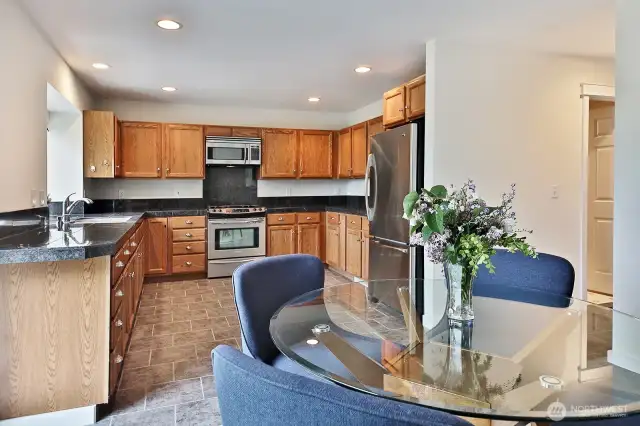 Propane stovetop/range. There's space for a center island, too! Open door at the far right edge of photo is to the laundry and utility room. Across from the laundry room is a half bath. Door to the garage is just beyond the right edge of the photo.