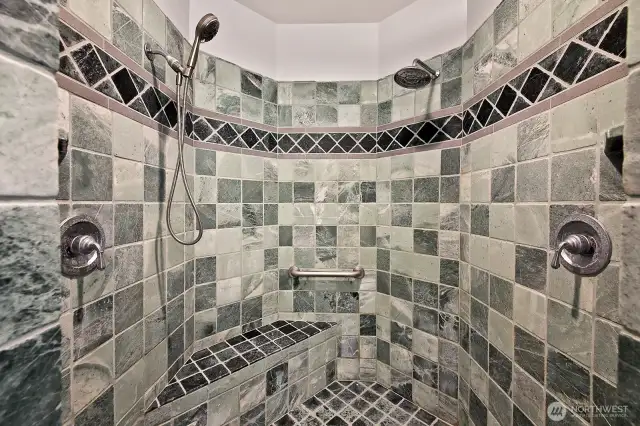 Double headed shower and a bench to sit.
