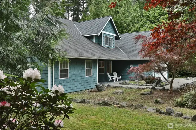 Cedar shingled with a sweet covered front porch, this is the eastern side of your home and what you see as you arrive.