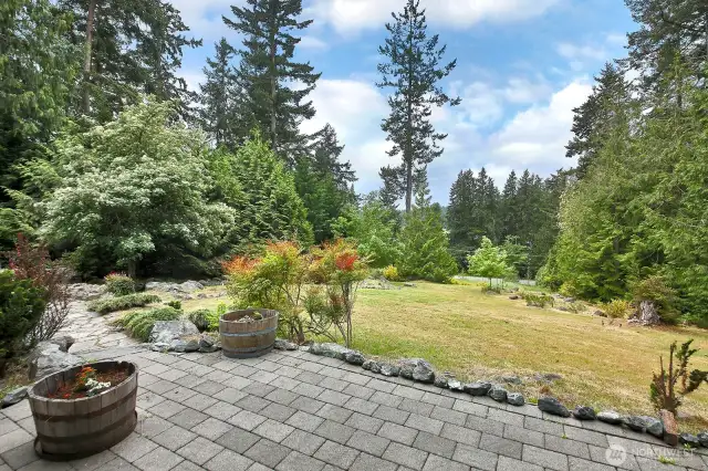 View of your backyard, gently sloping towards Bayview Road. Enjoy gorgeous sunsets from the patio that extends the entire length of your home.