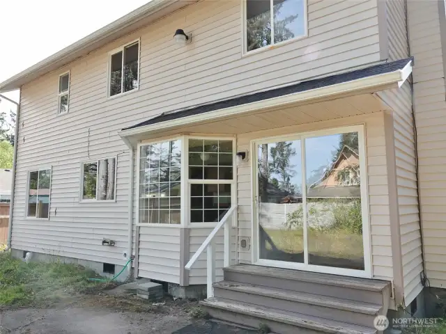 Rear w/ a slider off the Family Room leading to the back patio.
