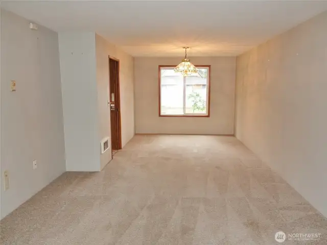 The Living Room flows directly into the Dining Room.