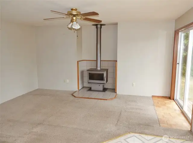 Family Room w/ free-standing wood fireplace.