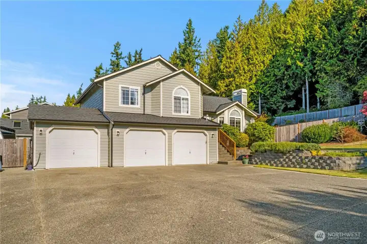Beautifully maintained home with striking curb appeal, a three-car garage, and a spacious driveway. Surrounded by mature trees and thoughtful landscaping, this property offers both privacy and charm in a peaceful neighborhood setting.