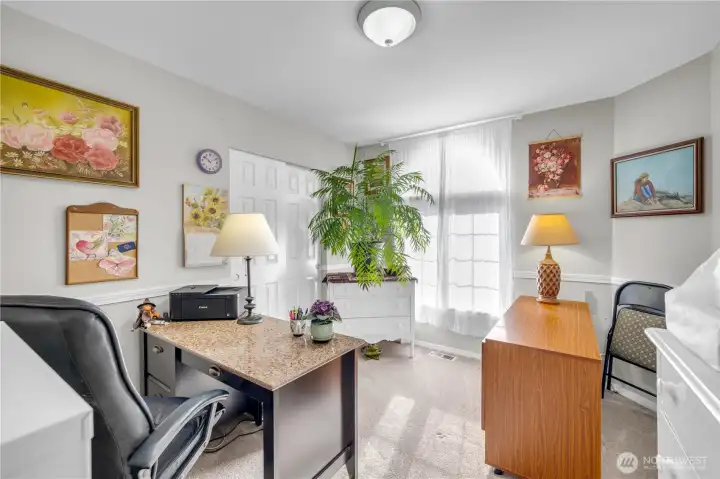 Sun-filled and inviting, this versatile room is perfect for a home office, art studio, or cozy reading nook. The large arched window brings in beautiful natural light, creating a warm and inspiring space.