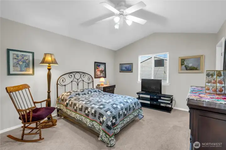 Spacious and serene, this bedroom features vaulted ceilings, soft natural light, and a calming neutral palette. A perfect retreat for rest and relaxation with plenty of room for your personal touches.