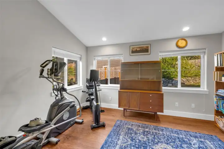 Versatile space with large windows, hardwood floors, and room for fitness equipment. Perfect for a home gym, hobby area, or quiet retreat.