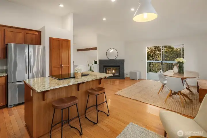 Kitchen with dining and living space with vaulted ceilings and deck. Territorial views abound from this space.