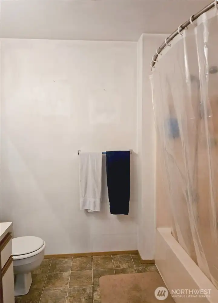 The primary bathroom includes a full tub and shower, offering a practical layout with neutral finishes and a comfortable amount of space for everyday routines.