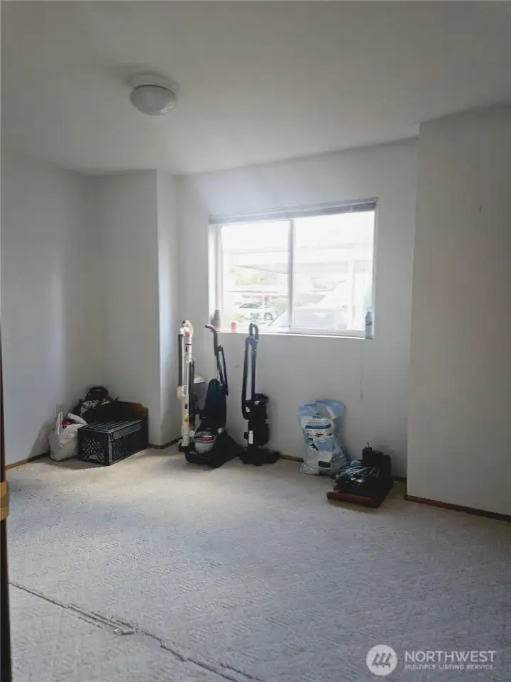 The second bedroom offers a versatile space with a large window that brings in natural light. Whether used as a guest room, home office, or hobby area, the room provides plenty of flexibility to suit your needs.