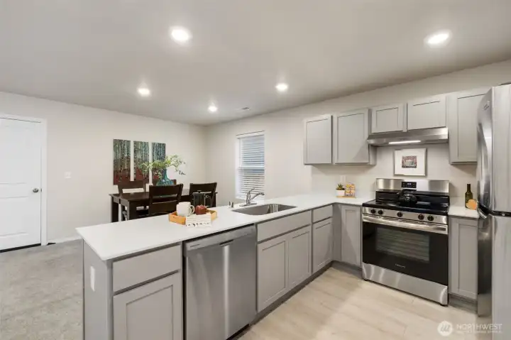 Modern kitchen with SS appliances.