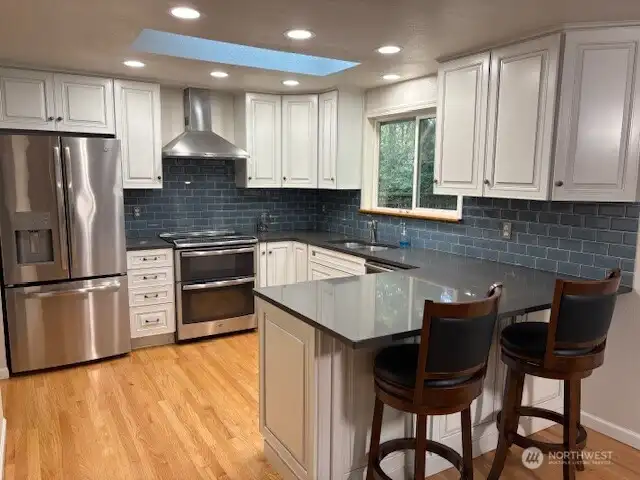 quartz countertops, newer apppliances w/pantry around the corner