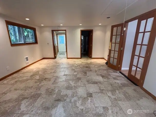 Media/bonus room with heated floors and access to dining room and exterior