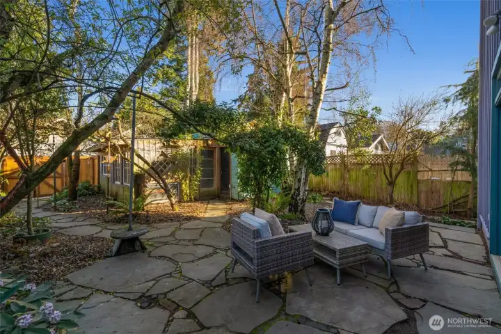 The property has alley access with a one car garage and a rustic garden shed/art studio space. New fence and gate were just built in the back of the property.