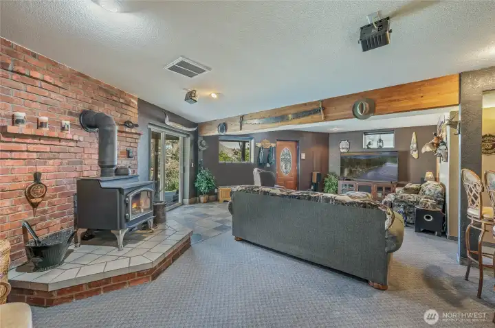 Daylight basement entertainment room, wood burning fireplace