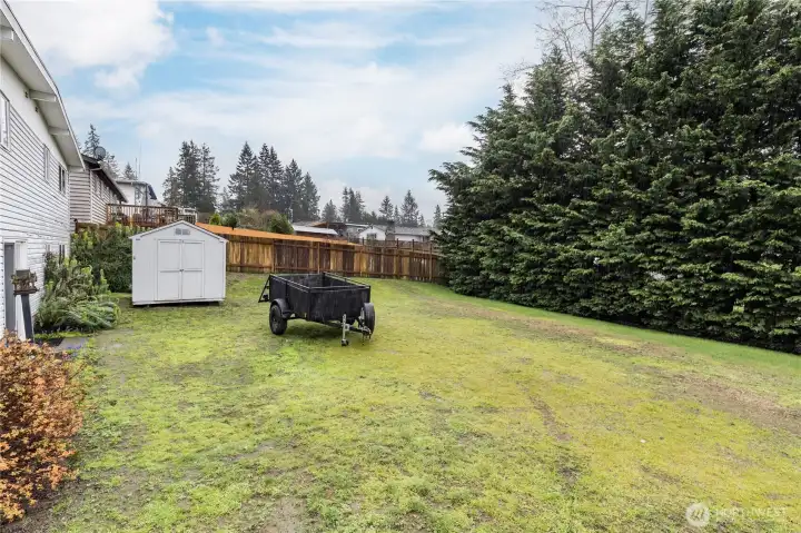 Beautiful mature cedars on the back edge of the property offer extra privacy