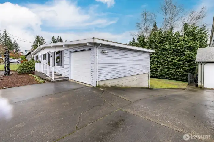 Extended driveway (shared with neighbor) provides convenient vehicle access to the back yard when needed