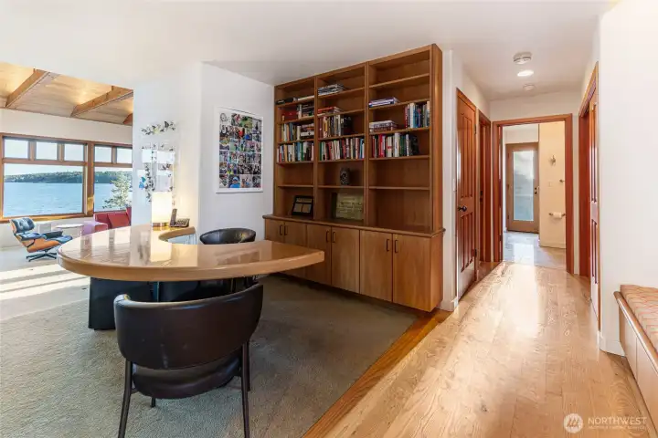 Dedicated office or library space with custom built-ins and warm wood finishes, ideal for work, study, or quiet retreat.